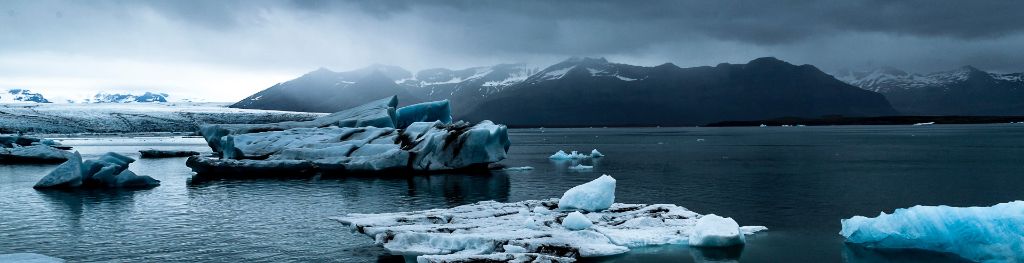 Icebergs beneath a grey sky Photo Emma Hall Icebergs beneath a grey sky Photo Emma Hall