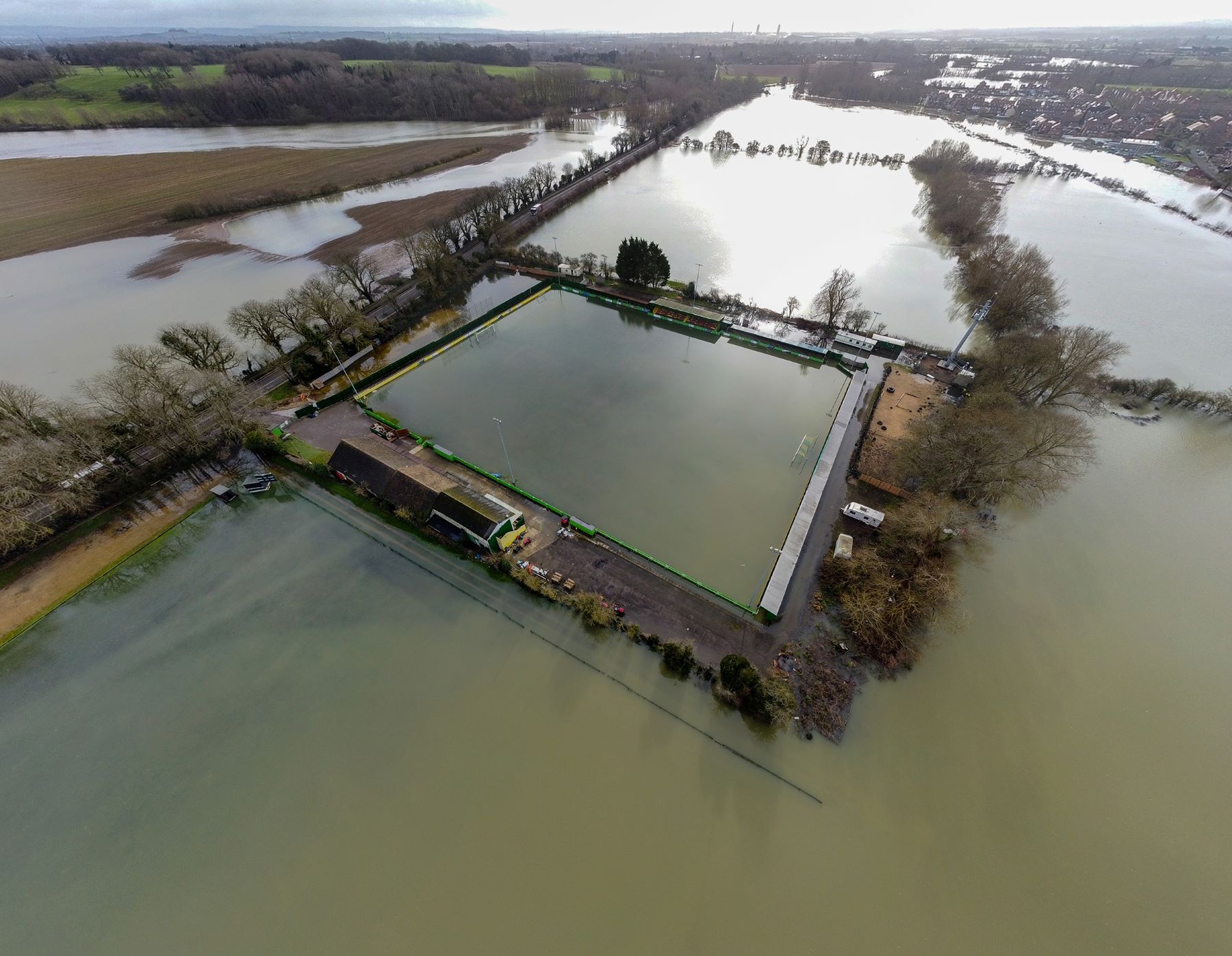 An aerial view of a flooded football club.