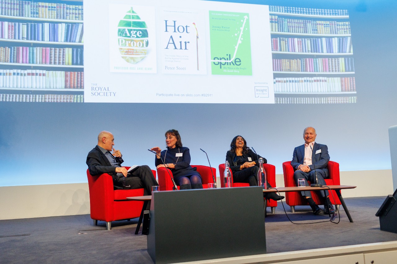 Professor Peter Stott MBE at the Royal Society Book Prize event in 2022 with Jim Al-Khalili. They are sitting on red chairs on a stage with a projection of Peter's book 'Hot air' behind them.